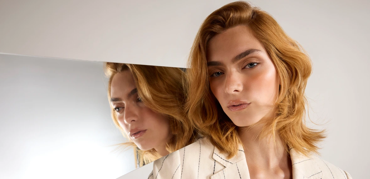 Two red-haired women reflected in a mirror, beauty editorial visual