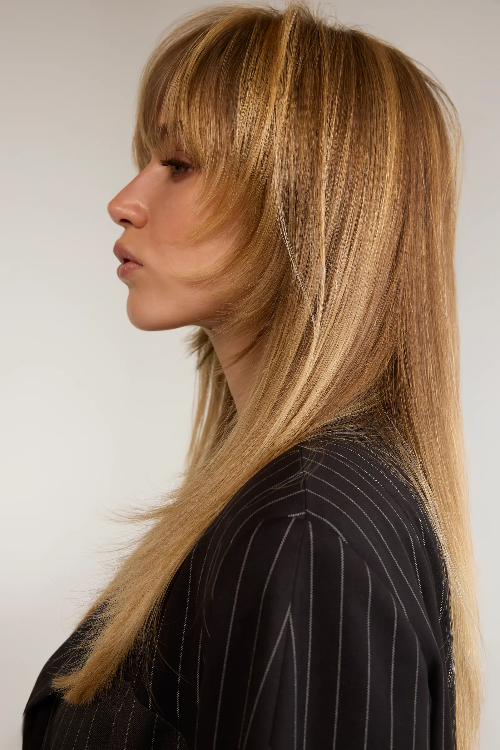 Profile of a model with long straight blonde hair